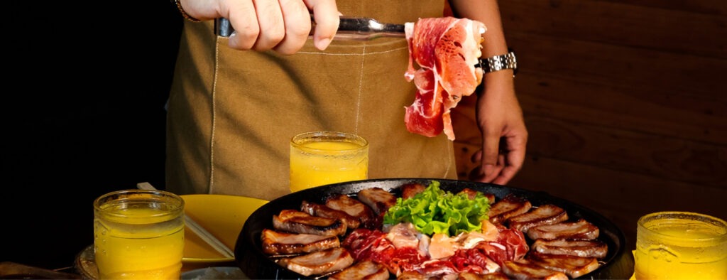 Friends grilling unlimited Korean BBQ beside the pool at F1 Hotel Manila, BGC