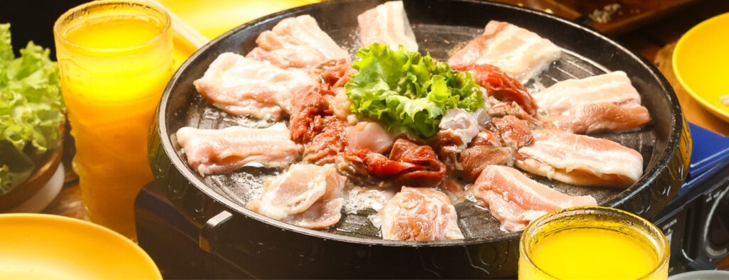 Friends grilling unlimited Korean BBQ beside the pool at F1 Hotel Manila, BGC