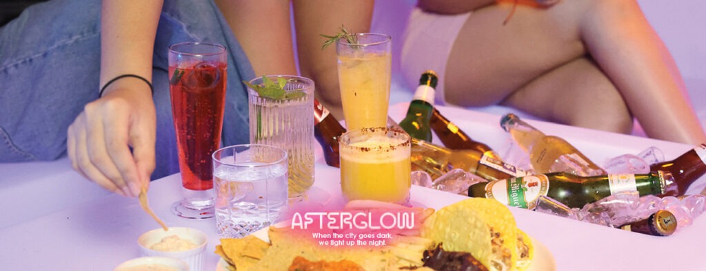 Rooftop DJ night with warm amber lighting and skyline view at F1 Hotel Manila